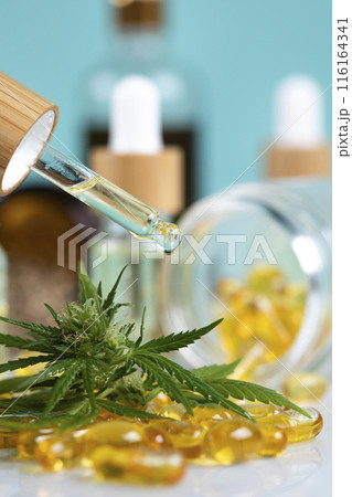Marijuana oil, leaf and capsules on a white background 116164341