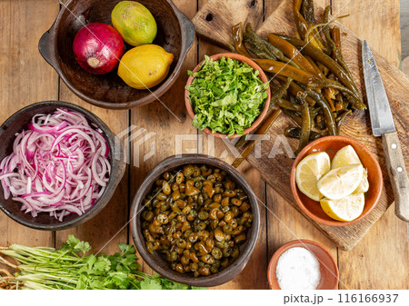 Ingredientes for seaweed cochayuyo seviche cebiche Chilean Australin peruvian cochayuyo, red onion, cilantro and lemon 116166937
