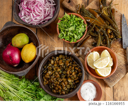 Ingredientes for seaweed cochayuyo seviche cebiche Chilean Australin peruvian cochayuyo, red onion, cilantro and lemon 116166955