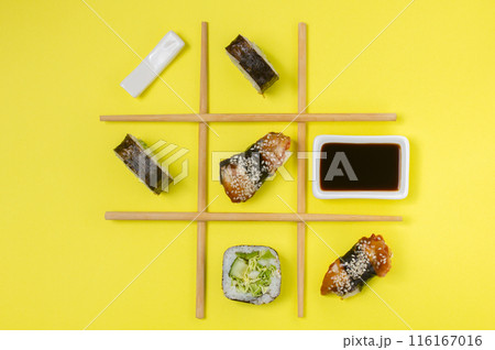 Creative Arrangement of Sushi and Sashimi on Yellow Background for Japanese Cuisine Concept. Creative Arrangement of Sushi and Sashimi on Yellow Background for Japanese Cuisine Concept. 116167016