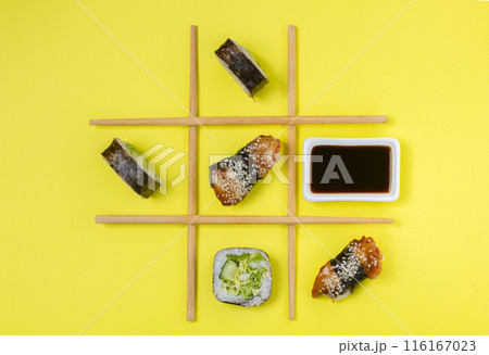 Creative Arrangement of Sushi and Sashimi on Yellow Background for Japanese Cuisine Concept Creative Arrangement of Sushi and Sashimi on Yellow Background for Japanese Cuisine Concept 116167023