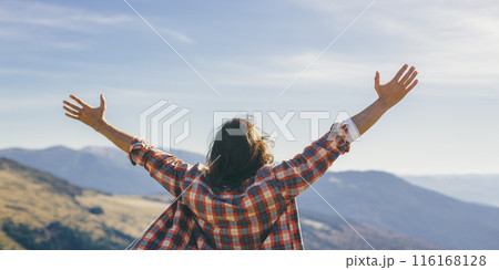 Joyful Person with Raised Hands on Scenic Mountain Top Joyful Person with Raised Hands on Scenic Mountain Top 116168128