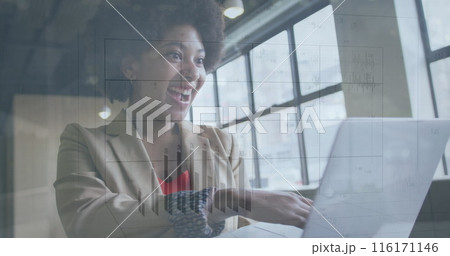 Image of changing numbers on graph over happy biracial woman scrolling on laptop Image of changing numbers on graph over happy biracial woman scrolling on laptop 116171146