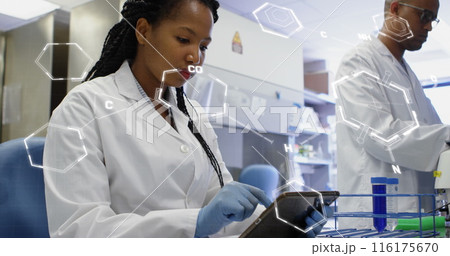 Image of medical data processing on african american female scientist using tablet at laboratory 116175670