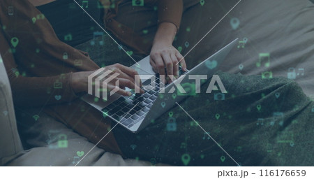 Image of network of connections with social media icons over caucasian women using laptop Image of network of connections with social media icons over caucasian women using laptop 116176659