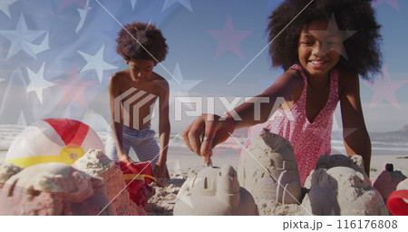 Image of flag of usa and stars over african american children playing at beach 116176808