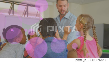 Image of glowing light over diverse school children with male teacher in classroom 116176845