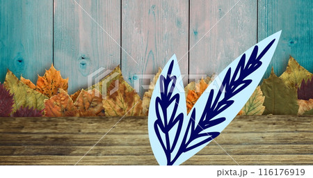Image of leaves and leaf drawing on wooden background 116176919