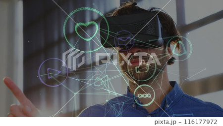 Caucasian tech pro in VR headset interacts with digital icons Caucasian tech pro in VR headset interacts with digital icons 116177972