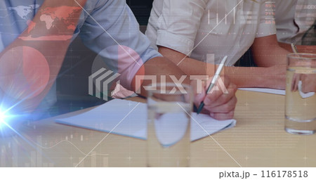 Person wearing pink shirt writing on paper, another in white rolling up sleeves Person wearing pink shirt writing on paper, another in white rolling up sleeves 116178518