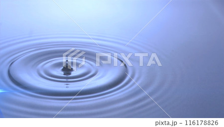 Image of water drops dropping into blue water with glowing light 116178826