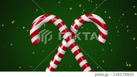 Image of stars over candy canes on green backrgound 116178920