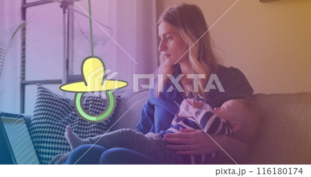 Image of dummy hanging over caucasian woman with baby Image of dummy hanging over caucasian woman with baby 116180174