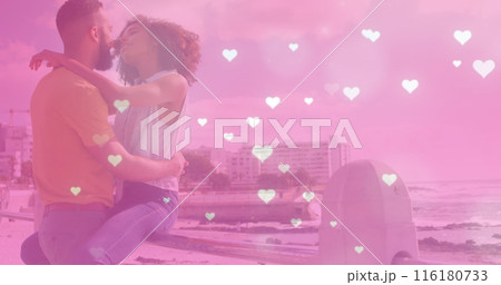 Image of heart icons over biracial couple at beach 116180733