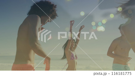 Image of light spots over happy diverse friends dancing at beach Image of light spots over happy diverse friends dancing at beach 116181775