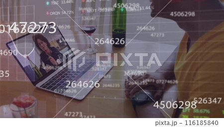 Biracial professional in yellow shirt intently views stock market data on laptop 116185840