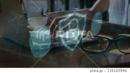 A young Caucasian professional woman, wearing glasses, typing on laptop 116185946