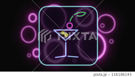 Neon sign showing martini glass with olive and cherry, glowing in purple hues 116186143
