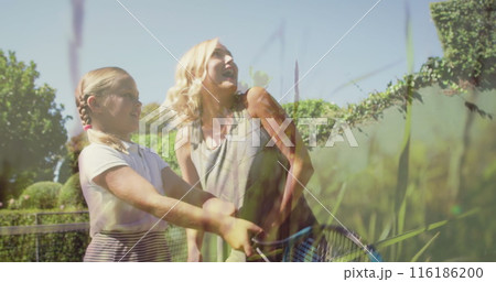 A young Caucasian athlete, wearing casual sportswear, playing tennis outdoors 116186200