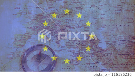 Compass resting on Europe map, yellow stars marking spots 116186236