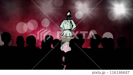 Woman in white chef outfit standing on stage, audience watching 116186687