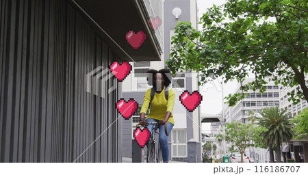 African American girlfriend/wife, wearing yellow top, riding bike in city African American girlfriend/wife, wearing yellow top, riding bike in city 116186707