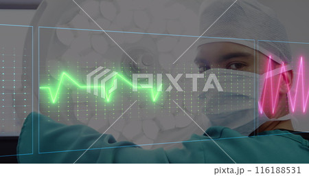 Middle Eastern male doctor in mask reviews digital heart rate monitors 116188531