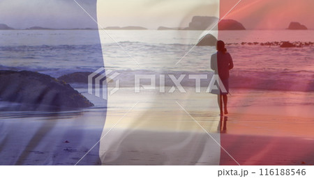 Image of flag of france over caucasian woman walking at beach 116188546