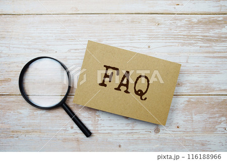 FAQ text message and magnifying glass with space copy on wooden background FAQ text message and magnifying glass with space copy on wooden background 116188966