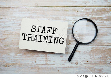 Staff Training text message and magnifying glass with space copy on wooden background Staff Training text message and magnifying glass with space copy on wooden background 116188974