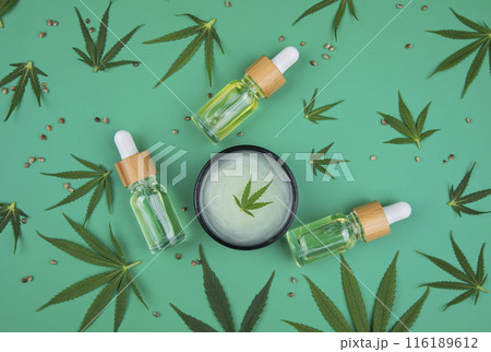Flat lay composition of marijuana and hemp seeds on green color paper background Flat lay composition of marijuana and hemp seeds on green color paper background 116189612