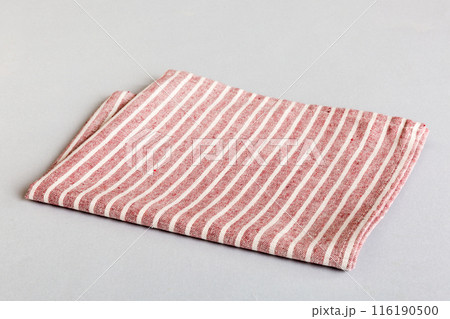 top view with red empty kitchen napkin isolated on table background. Folded cloth for mockup with copy space, Flat lay. Minimal style top view with red empty kitchen napkin isolated on table background. Folded cloth for mockup with copy space, Flat lay. Minimal style 116190500