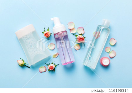 Fancy healthcare bottles for serum, micellar, tonic, toner, lotion, water and cream with rose flower. Natural oranic spa cosmetics concept. Mockup, template, Top view Fancy healthcare bottles for serum, micellar, tonic, toner, lotion, water and cream with rose flower. Natural oranic spa cosmetics concept. Mockup, template, Top view 116190514