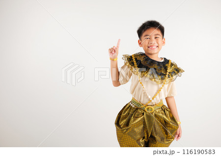 Portrait Thailand kid boy smiling traditional Thai dress costume makes gesture fingers point upwards above presenting product something, studio isolated white background, primary child man smile Portrait Thailand kid boy smiling traditional Thai dress costume makes gesture fingers point upwards above presenting product something, studio isolated white background, primary child man smile 116190583