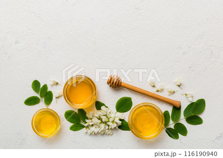 honey jar with acacia flowers and leaves. fresh honey top view flat lay 116190940