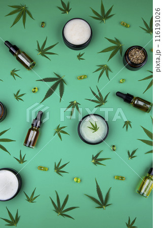 Flat lay composition of marijuana and hemp seeds on green color paper background Flat lay composition of marijuana and hemp seeds on green color paper background 116191026