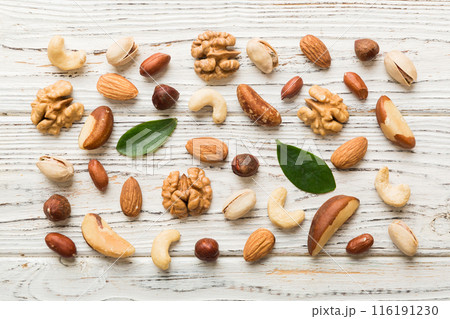 Composition of nuts , flat lay - mix hazelnuts, cashews, almonds on table background. healthy eating concepts and food background Composition of nuts , flat lay - mix hazelnuts, cashews, almonds on table background. healthy eating concepts and food background 116191230
