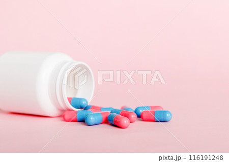 plastic medicine bottle with capsules of pills on colored background. Online pharmacy. Painkiller medicine and antibiotic drug resistance concept. Pharmaceutical industry 116191248