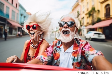 Senior couple have fun together and drive cabrio car around the city, unusual date concept 116192160