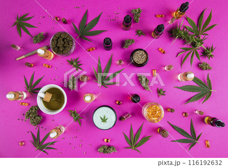 Cannabis leaf with oil bottle and hemp seeds on a pink background Cannabis leaf with oil bottle and hemp seeds on a pink background 116192632