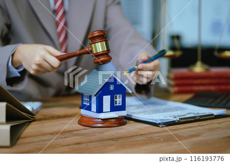 Justice and law concept. Real Estate Law in a courtroom the gavel, working with digital tablet computer on wood table in sun light. 116193776
