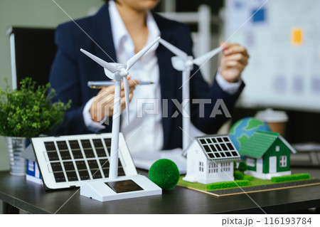 Businessman team brainstorming using tablet, laptop computer for working technology and business,  Renewable energy-based green businesses and global warming. Reduce CO2 emission. 116193784