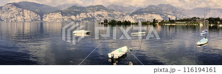 Alpine Panorama on Lake Garda in Italy with Few Moored Boats Before the Start of the Holiday Season 116194161