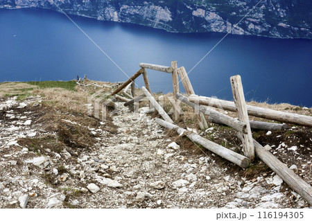 Repair-Needed Wooden Railing on Hiking Trail from Monte Baldo to Lake Garda 116194305