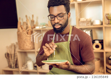 African american guy working with pottery in his workshop 116195649