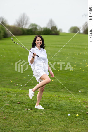 Beautiful woman showcasing her talent in golfing Beautiful woman showcasing her talent in golfing 116195690