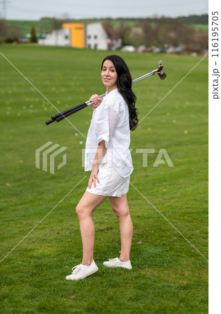 Sporty woman player enjoying the game on the green lawn Sporty woman player enjoying the game on the green lawn 116195705