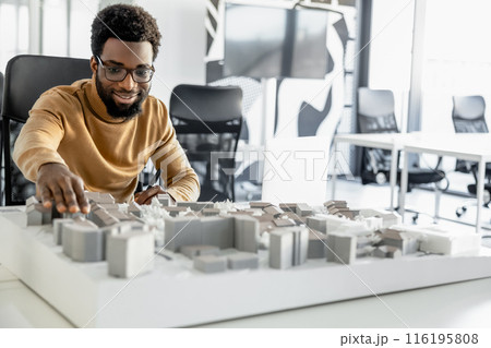 African american architect working in his office and looking involved African american architect working in his office and looking involved 116195808