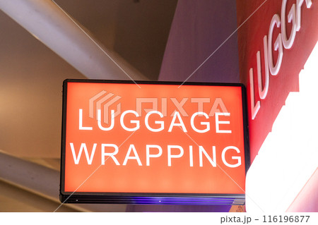 Luggage wrapping services word at airports using shrink film at airports to protect baggages and luggages before checking in. 116196877