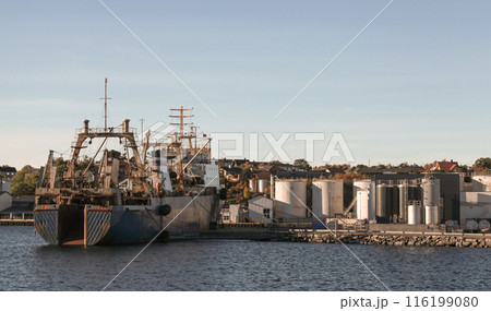 Kristiansund port view, trawler ship is moored in front of tanks Kristiansund port view, trawler ship is moored in front of tanks 116199080